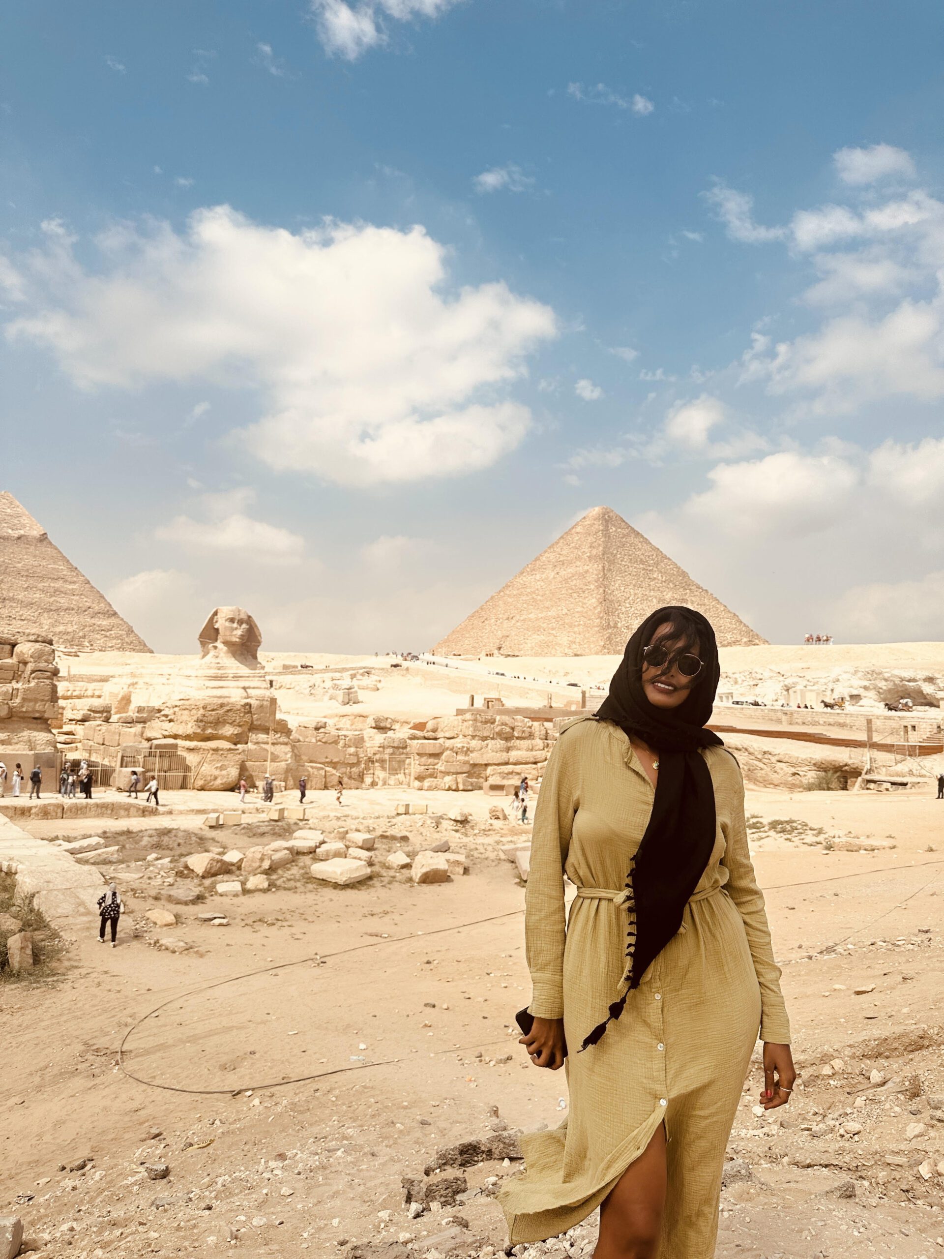 Solo female traveler exploring the Cairo pyramids during a travel adventure in Egypt