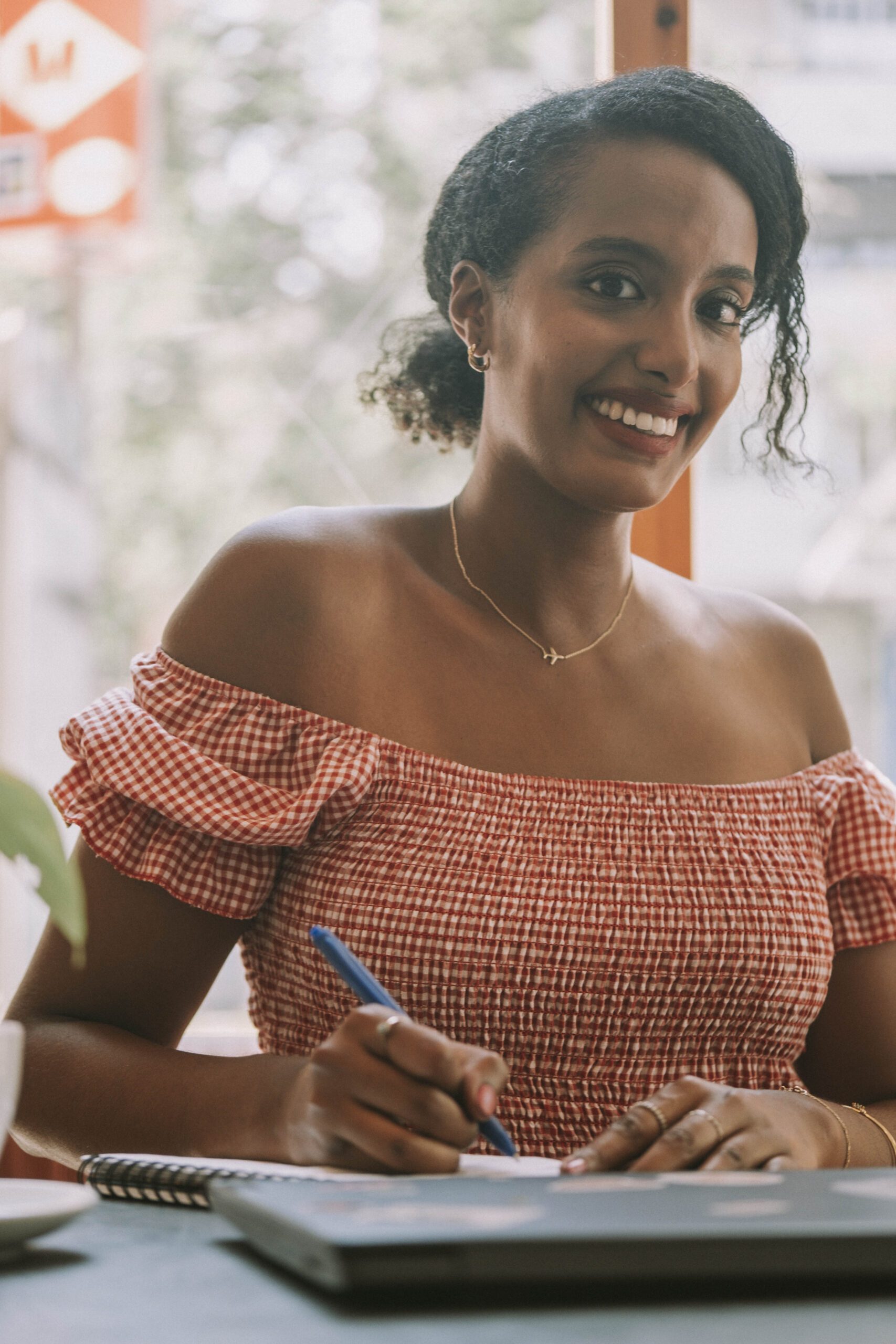 Woman digital nomad managing work on her laptop abroad