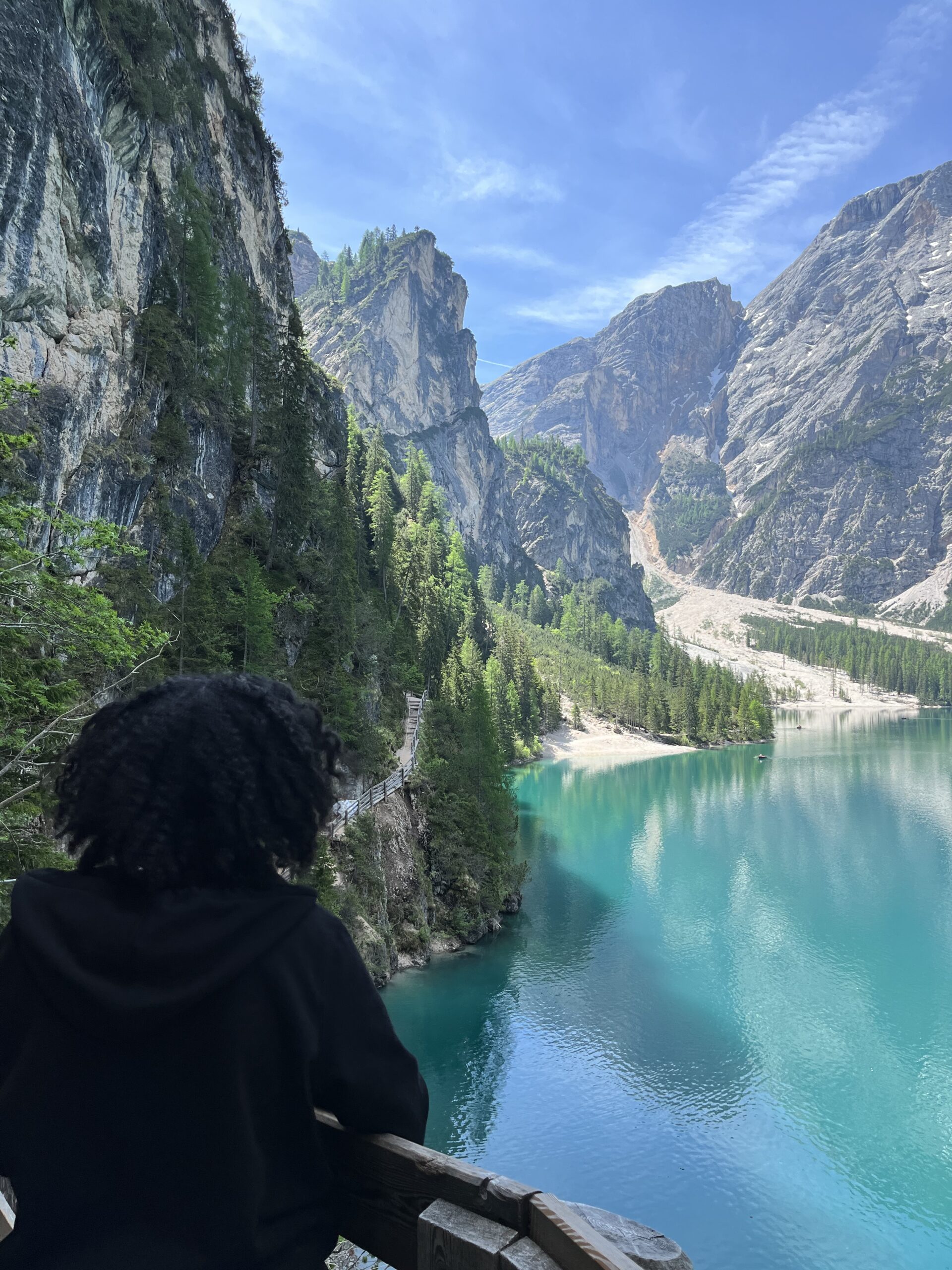Female solo traveler taking photos of Dolomites peaks