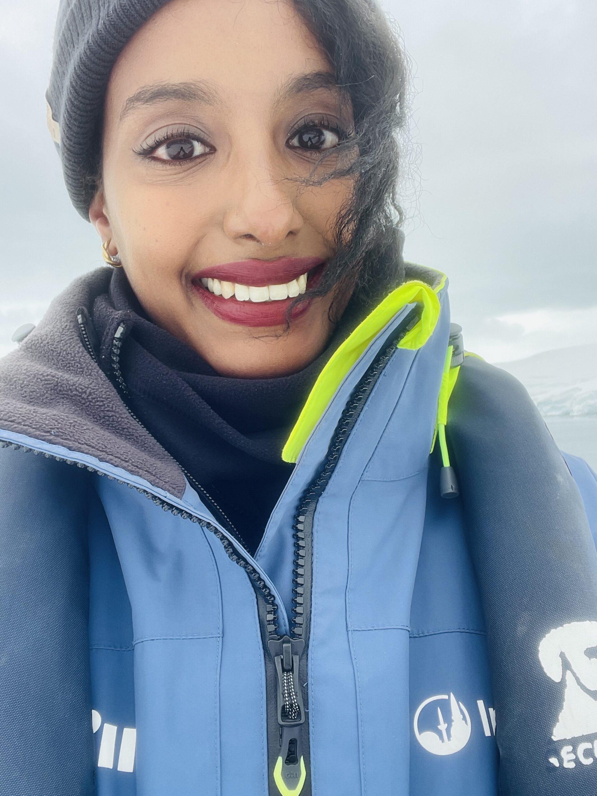 Solo female traveler on a Zodiac boat tour through Antarctica's icy landscapes