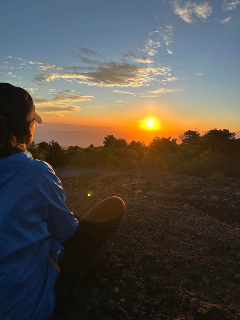 Solo female traveler enjoying a sunset view in Sicily, Italy with scenic landscape