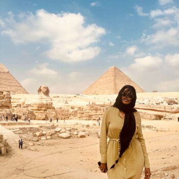 Solo female traveler exploring the Pyramids of Giza in Cairo, Egypt