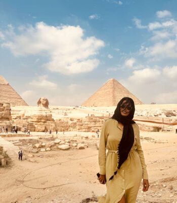 Solo female traveler exploring the Pyramids of Giza in Cairo, Egypt