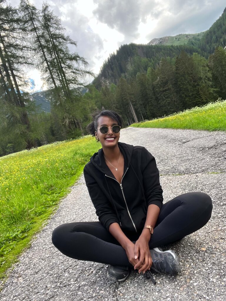 Solo female traveler hiking in the Dolomites mountains, enjoying adventure travel in Italy