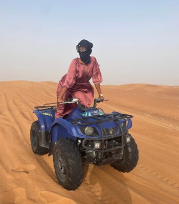 Woman traveling alone in Dubai desert dunes
