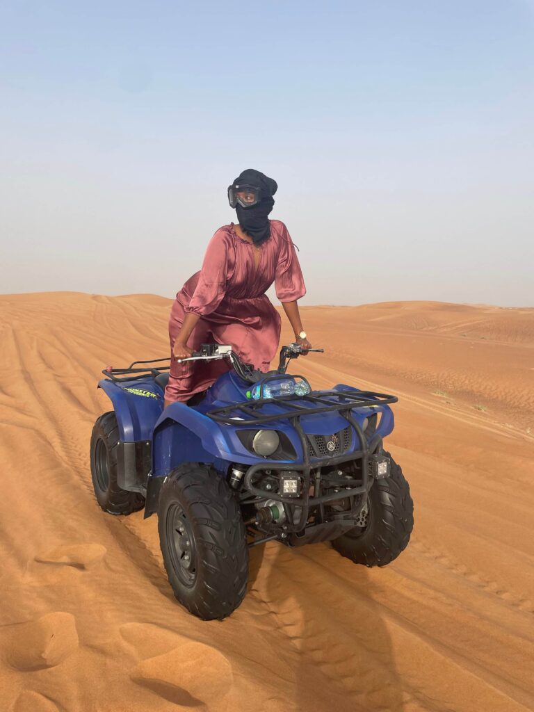 Woman traveling alone in Dubai desert dunes