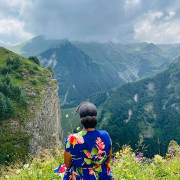 Solo female traveler hiking in the mountains of Georgia with scenic mountain views