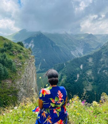 Solo female traveler hiking in the mountains of Georgia with scenic mountain views
