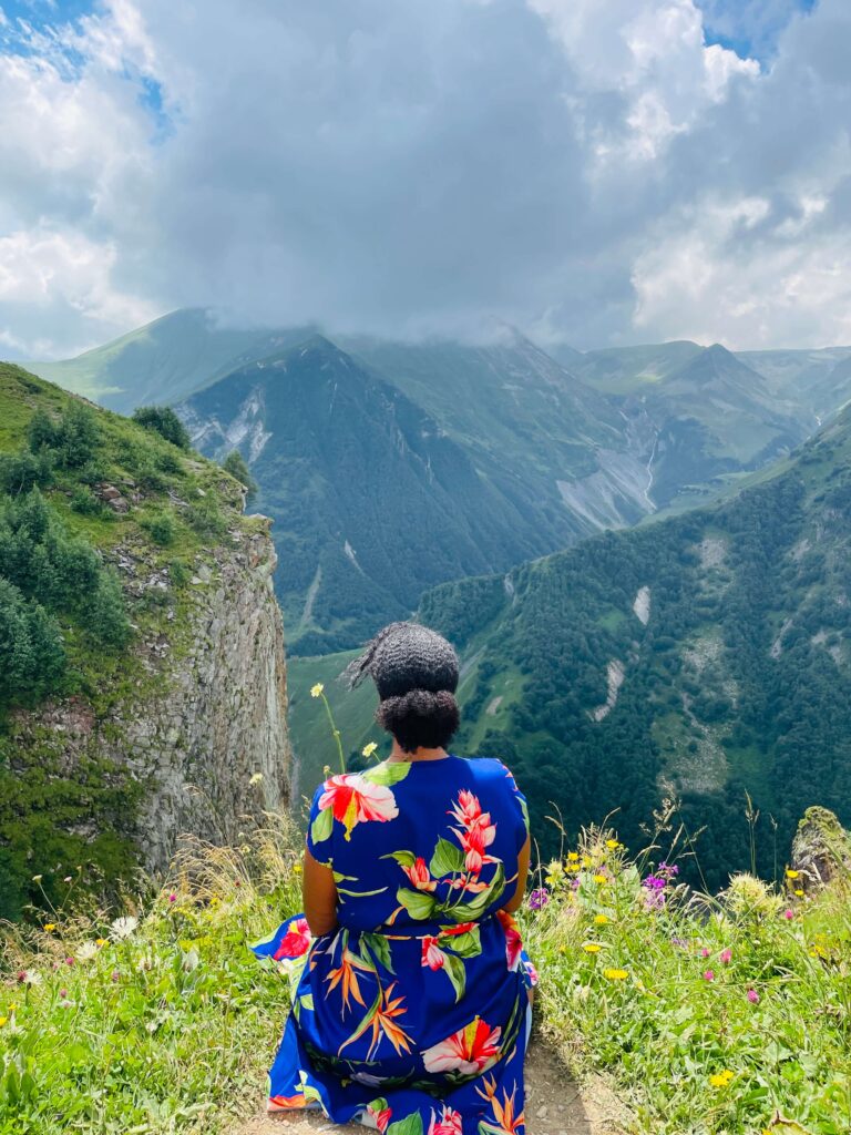 Solo female traveler hiking in the mountains of Georgia with scenic mountain views