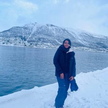 Solo female traveler exploring snowy winter wonderland in Norway