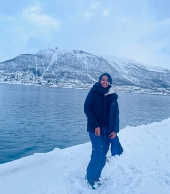 Solo female traveler exploring snowy winter wonderland in Norway