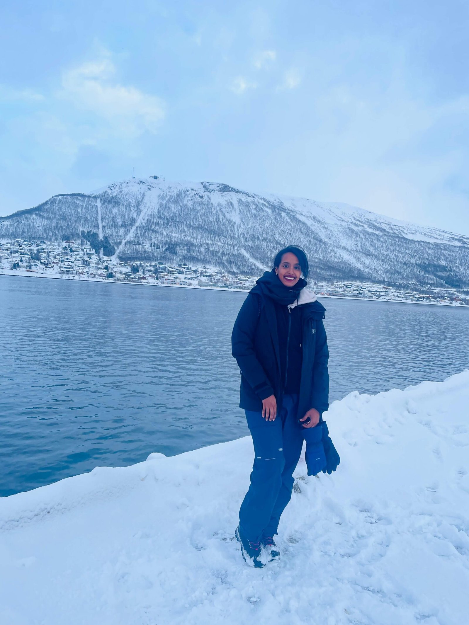 Solo female traveler exploring snowy winter wonderland in Norway
