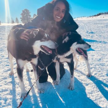 Solo female traveler enjoying a husky sled tour in Norway