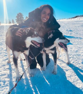 Solo female traveler enjoying a husky sled tour in Norway