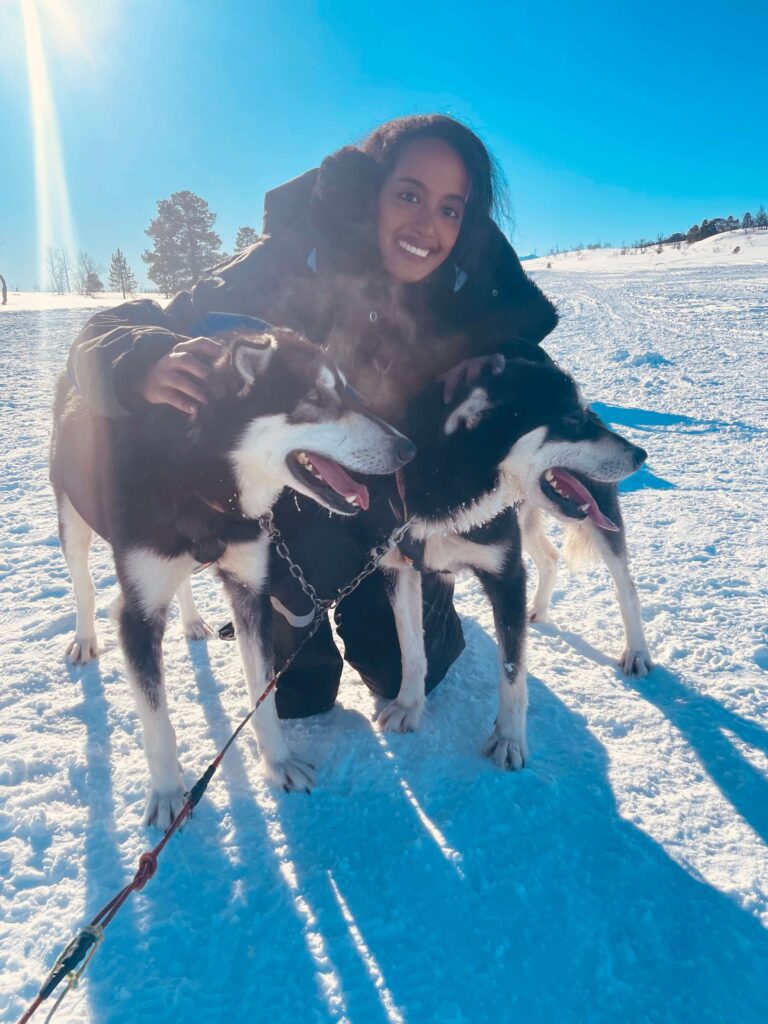 Solo female traveler enjoying a husky sled tour in Norway