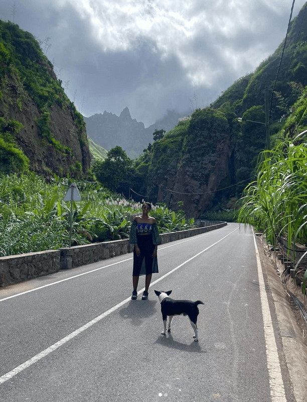 Solo female traveler hiking in Cape Verde with her dog, exploring scenic trails