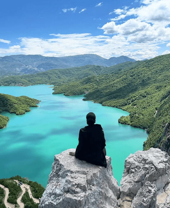 Solo female traveler hiking in the mountains of Albania, exploring nature and scenic trails