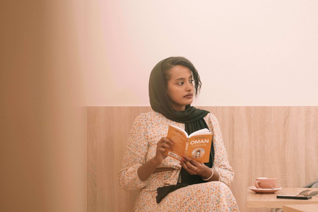 Solo female traveler exploring coffee shops and cafes in Oman, enjoying local coffee culture.