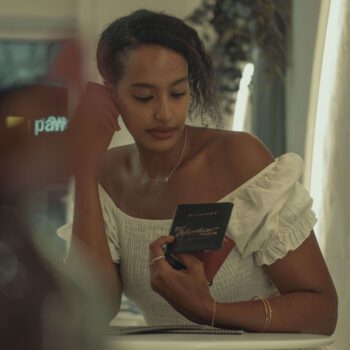 Solo female traveler holding passport, dreaming of travel and adventure