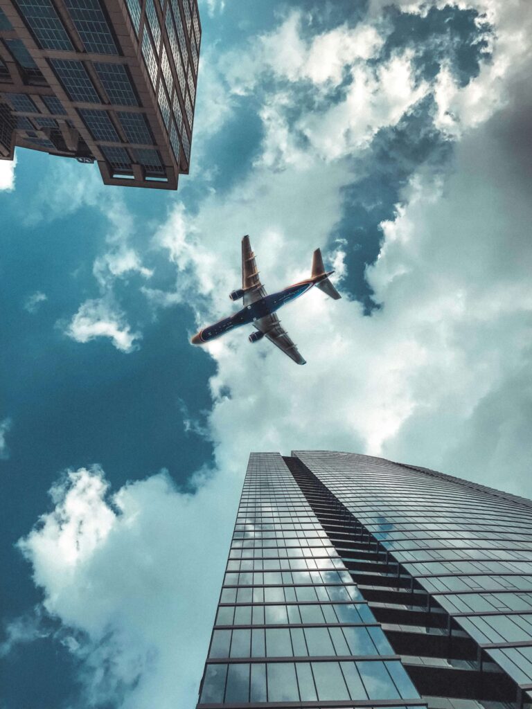 Airplane flying in the sky, symbolizing solo female travel adventures
