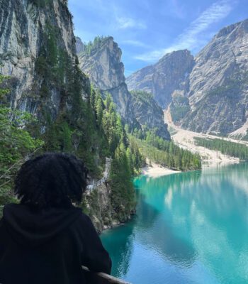 Female solo traveler taking photos of Dolomites peaks