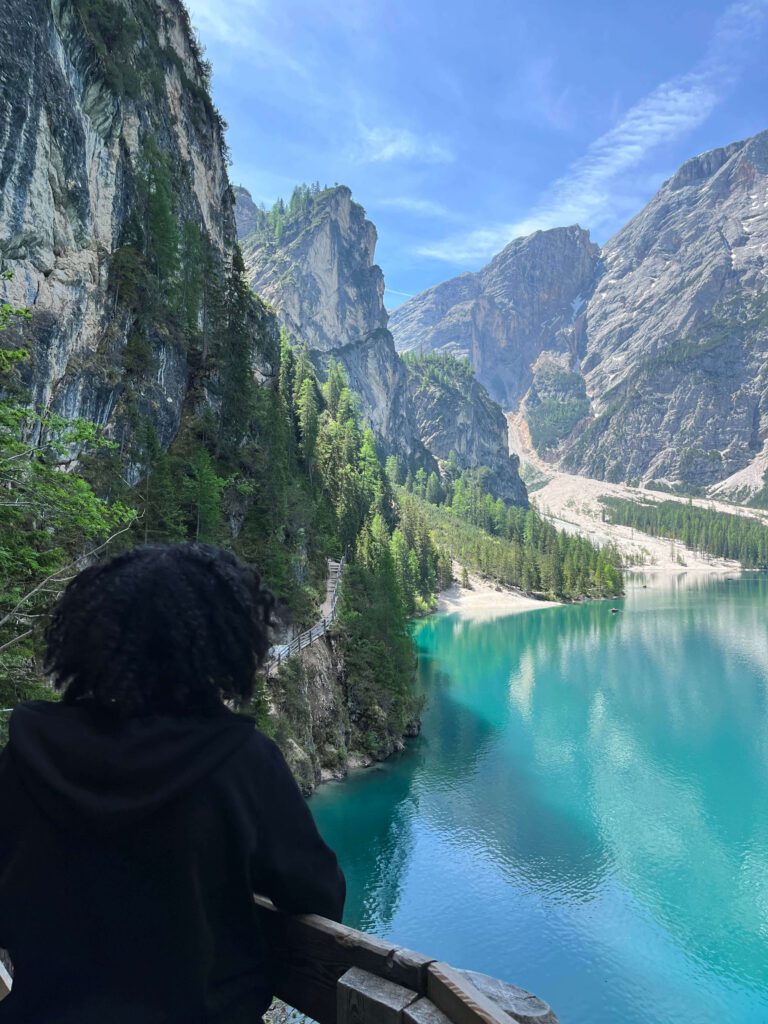 Female solo traveler taking photos of Dolomites peaks