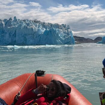 Solo female travel in Greenland Zodiac boat adventure with iceberg views