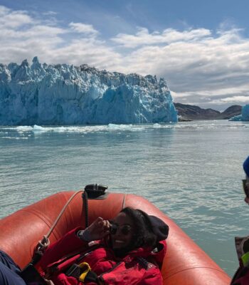 Solo female travel in Greenland Zodiac boat adventure with iceberg views