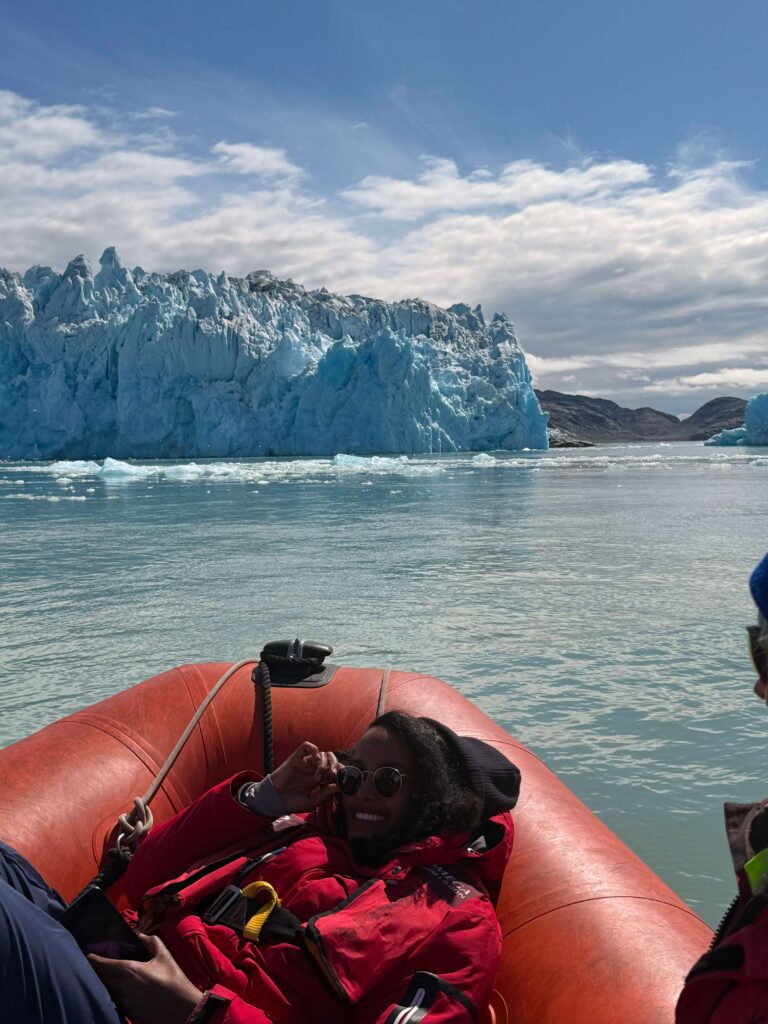 Solo female travel in Greenland Zodiac boat adventure with iceberg views