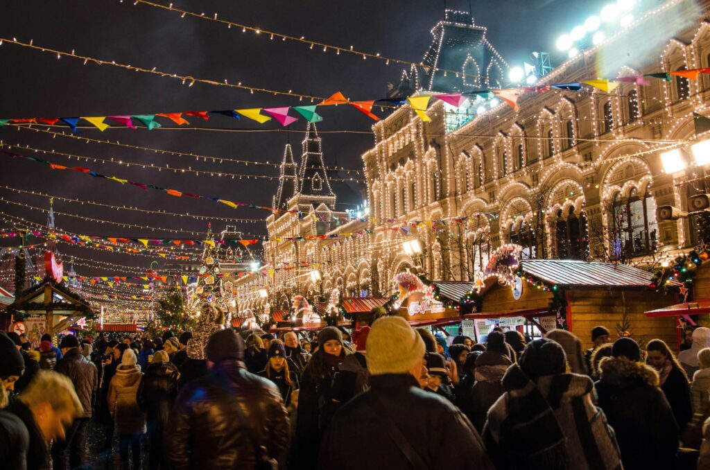 Colorful Christmas market with carousel and lights perfect for solo winter adventures for solo female travelers