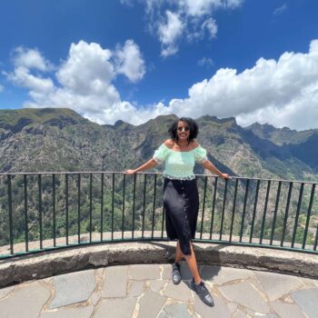 Solo traveler walking along coastal hiking trail in Madeira