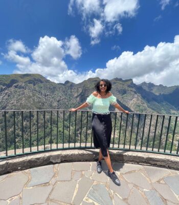 Solo traveler walking along coastal hiking trail in Madeira