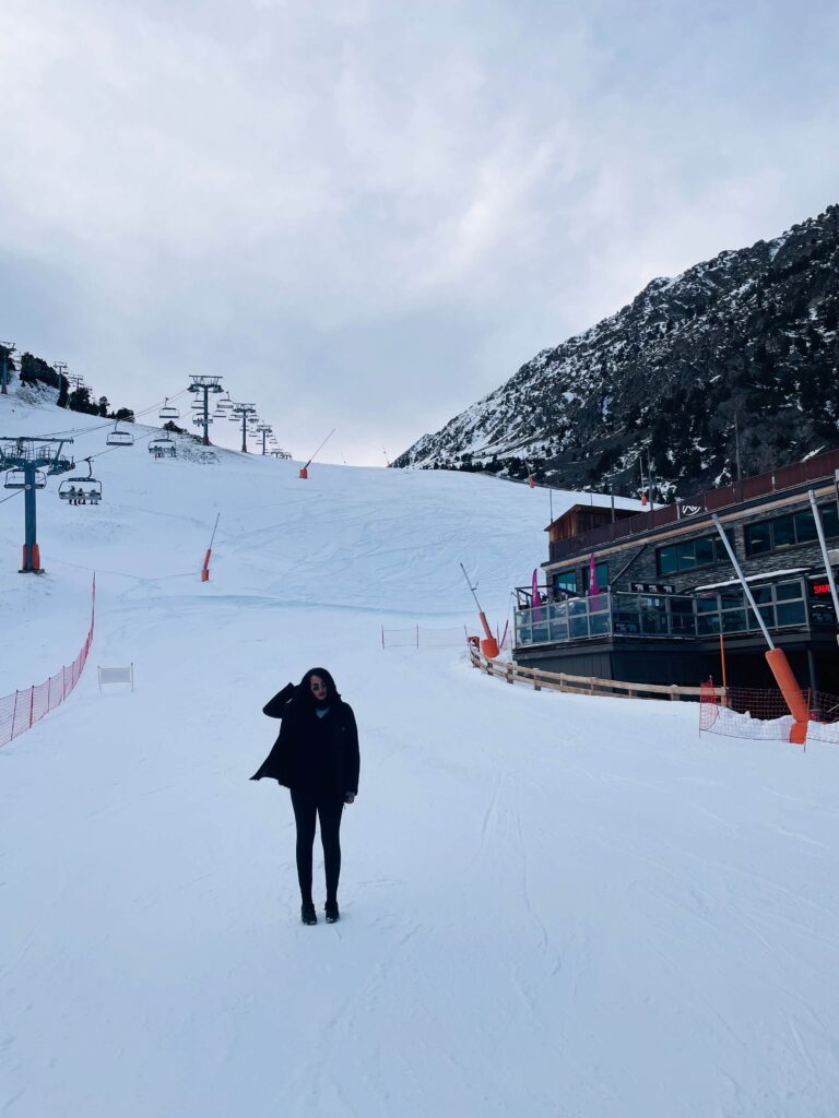 Solo female traveler exploring snow-covered mountains in Andorra