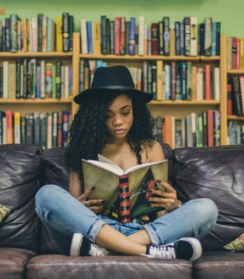 Solo female traveler reading travel books for inspiration and trip planning