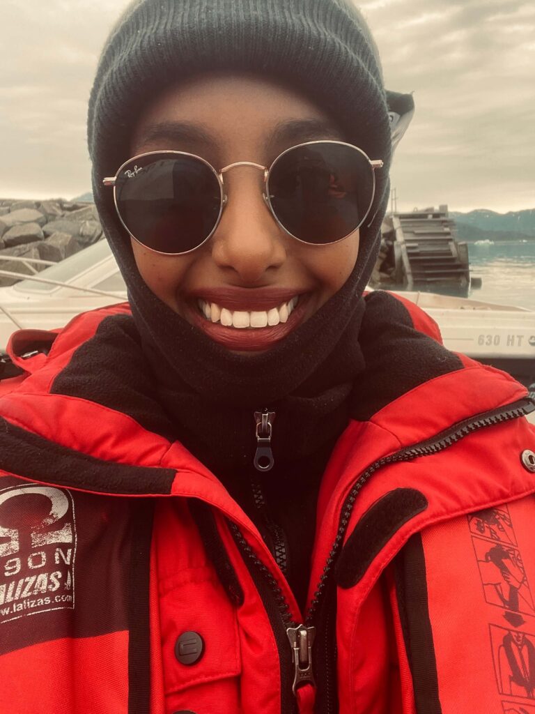 Solo female traveler exploring the icy landscapes of Greenland