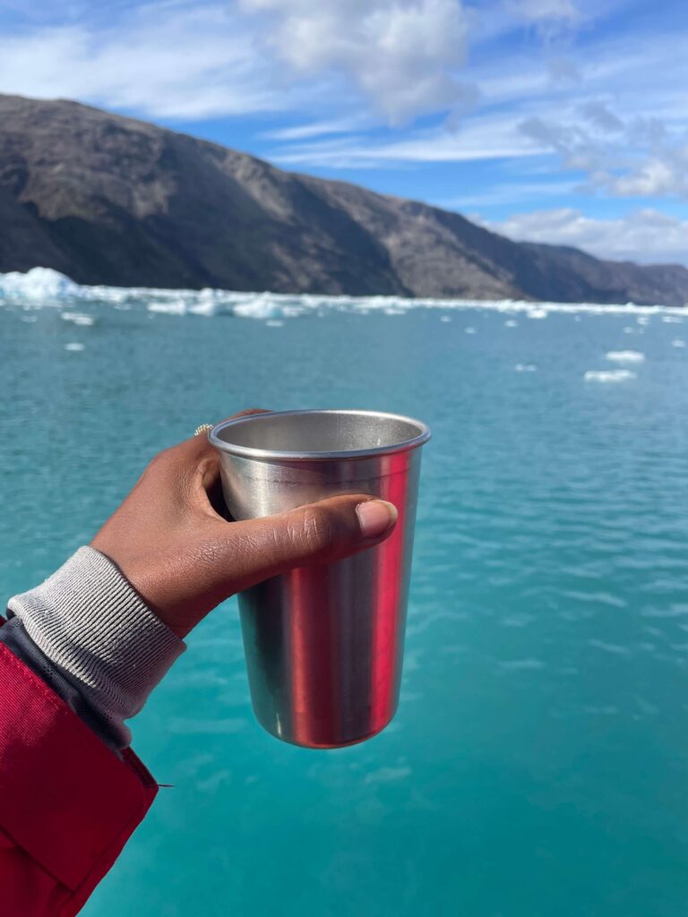Solo female traveler exploring Greenland icebergs on Zoociad Arctic adventure