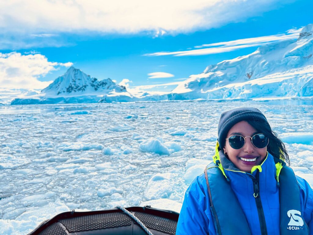 Solo female traveler exploring Antarctica among glaciers and penguins