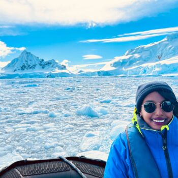 Solo female traveler exploring Antarctica among glaciers and penguins