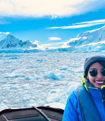 Solo female traveler exploring Antarctica among glaciers and penguins
