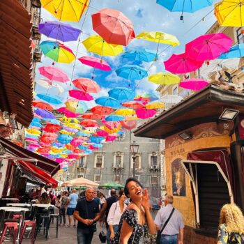 Solo female traveler exploring the beautiful streets and coastline of Sicily, Italy while traveling alone safely and confidently