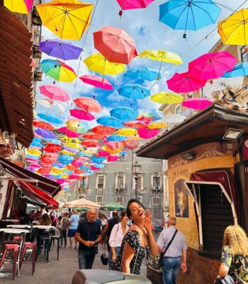 Solo female traveler exploring the beautiful streets and coastline of Sicily, Italy while traveling alone safely and confidently