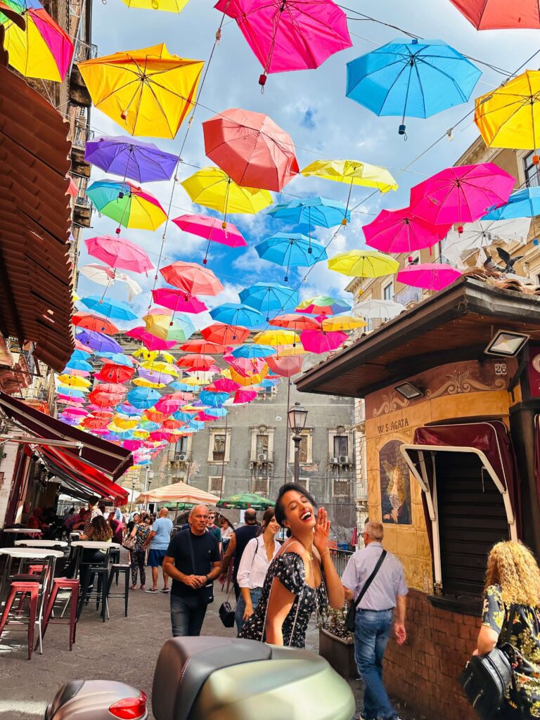 Solo female traveler exploring the beautiful streets and coastline of Sicily, Italy while traveling alone safely and confidently