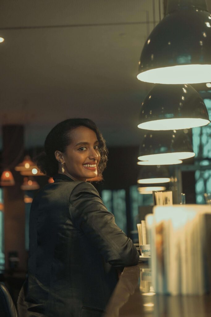 Solo female traveler working remotely on a laptop in Barcelona, enjoying the city and cafe culture