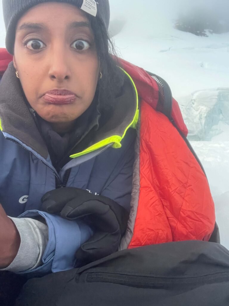 Solo female traveler camping in Antarctica surrounded by snow and ice