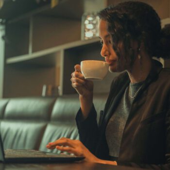 Solo female traveler working remotely from café in Barcelona