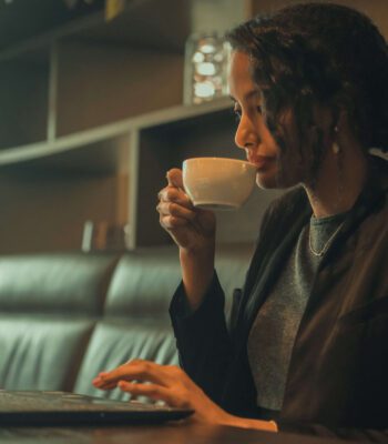 Solo female traveler working remotely from café in Barcelona
