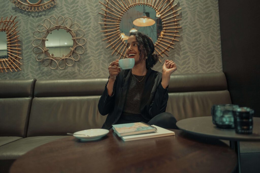 Solo female traveler discovering a new city while enjoying coffee at a local café