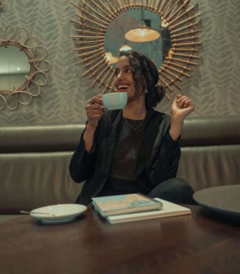 Solo female traveler discovering a new city while enjoying coffee at a local café