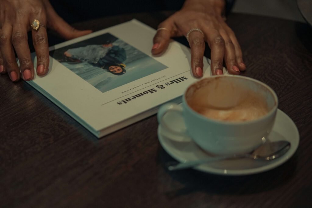 Solo female traveler planning a trip with a travel book in a coffee shop