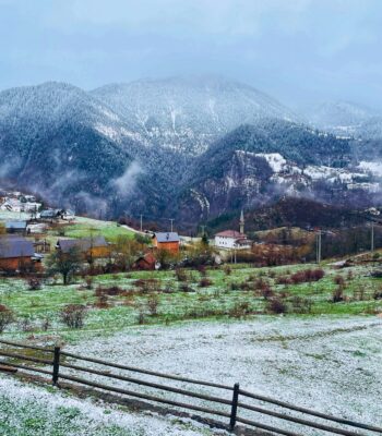 Solo female traveler exploring Peja in Kosovo with dramatic mountain cliffs